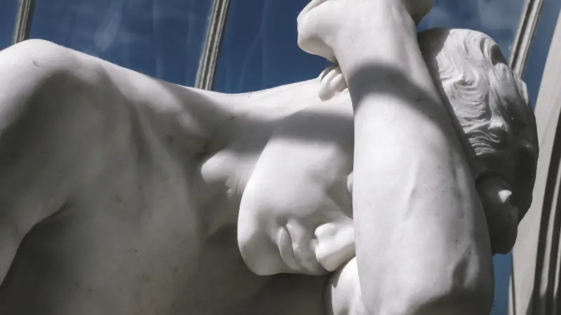 Close-up of a marble statue in a museum gallery