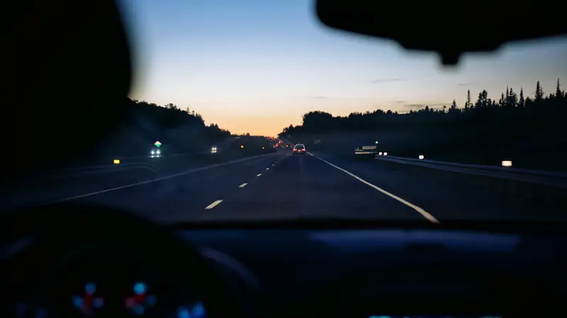 Dashboard and windscreen view of a motorway at night