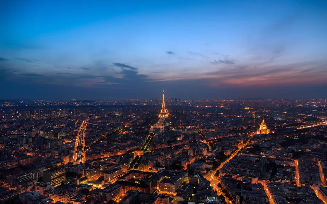 Paris at dusk from above, with the Eiffel Tower lit up