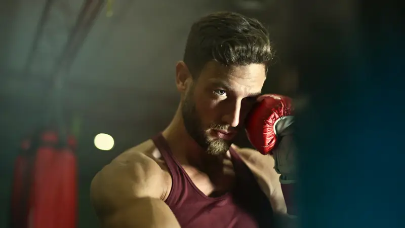Boxer in red gloves in a guard stance