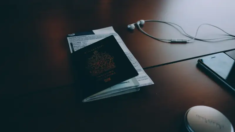 Passport and travel documents on a dark table