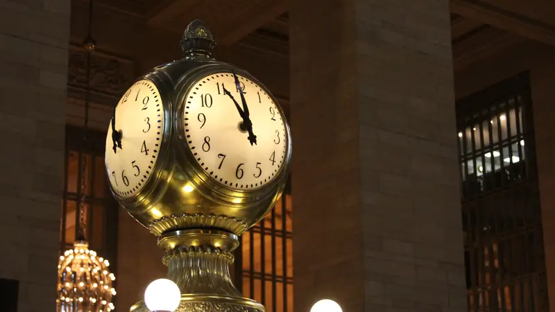 Ornate four-faced clock in a grand station concourse