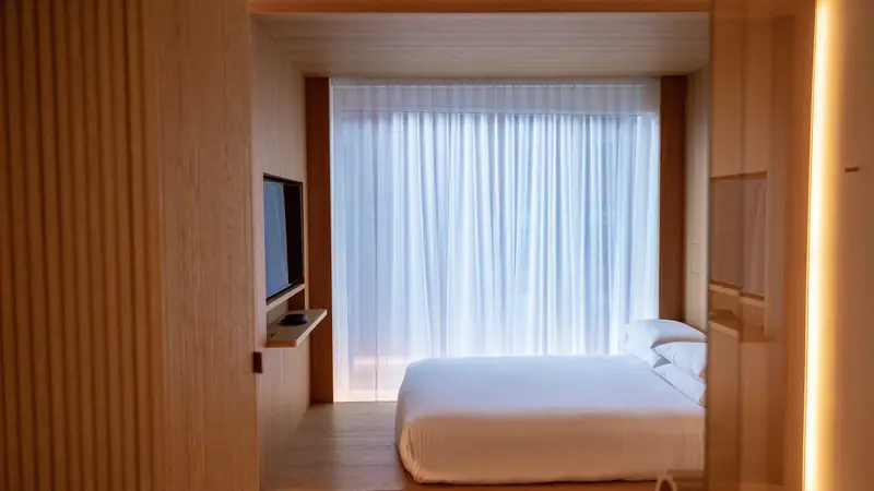 Minimalist design hotel room with warm wood panelling