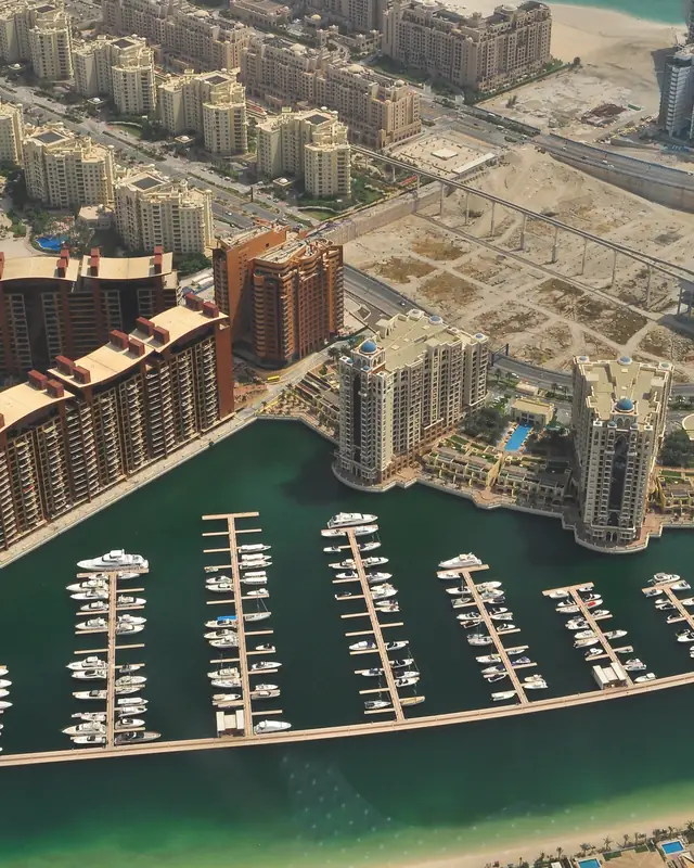 Aerial view of a Dubai waterfront marina and hotel towers