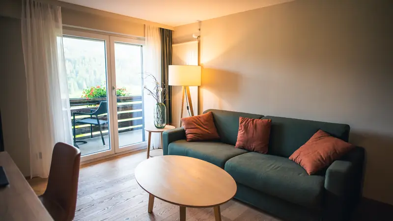Serviced apartment living room with sofa and balcony doors