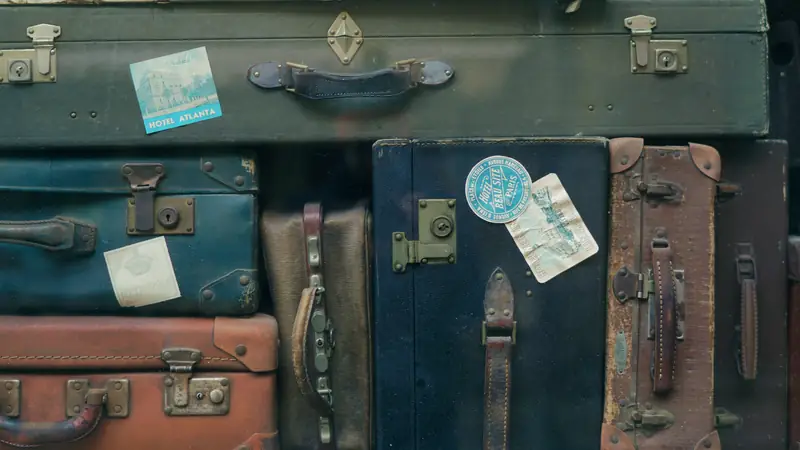 Stack of vintage suitcases with travel stickers