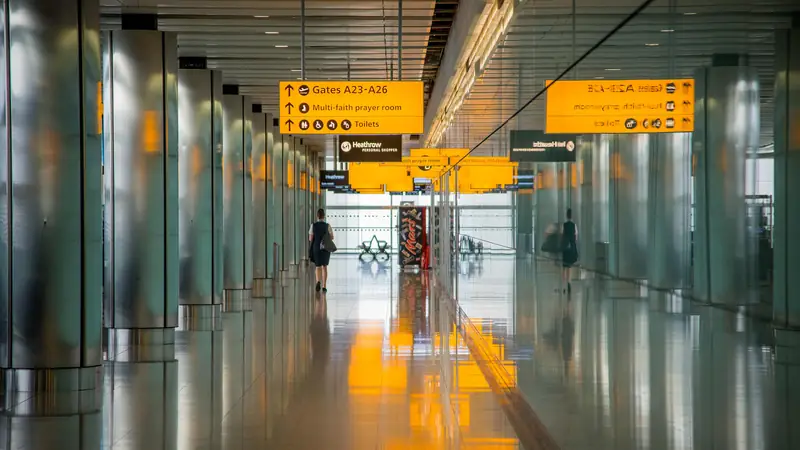 Empty airport corridor with overhead gate signs