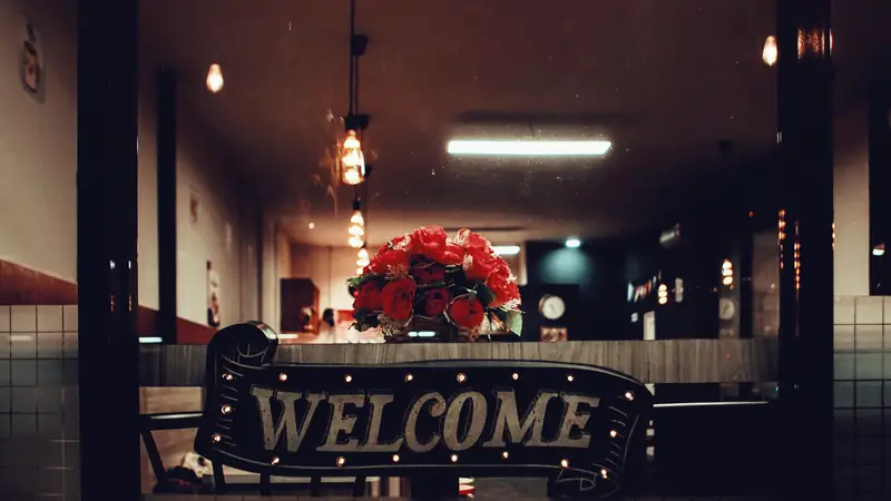 Illuminated welcome sign at a reception desk